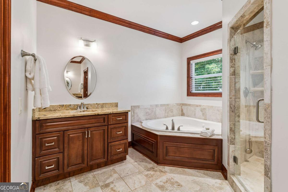 150 Rice Mill St. Simons Island, GA 31522 - Photo 15 of 38 a spacious bathroom with a tub sink and mirror