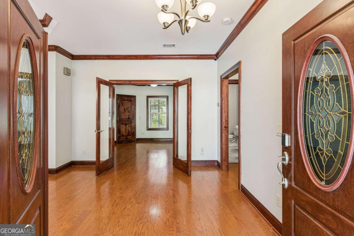 150 Rice Mill St. Simons Island, GA 31522 - Photo 2 of 38 a view of a hallway with wooden floor