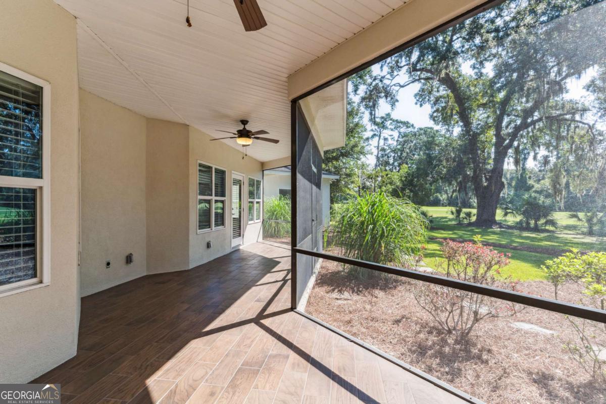 150 Rice Mill St. Simons Island, GA 31522 - Photo 26 of 38 a view of balcony with wooden floor and fence
