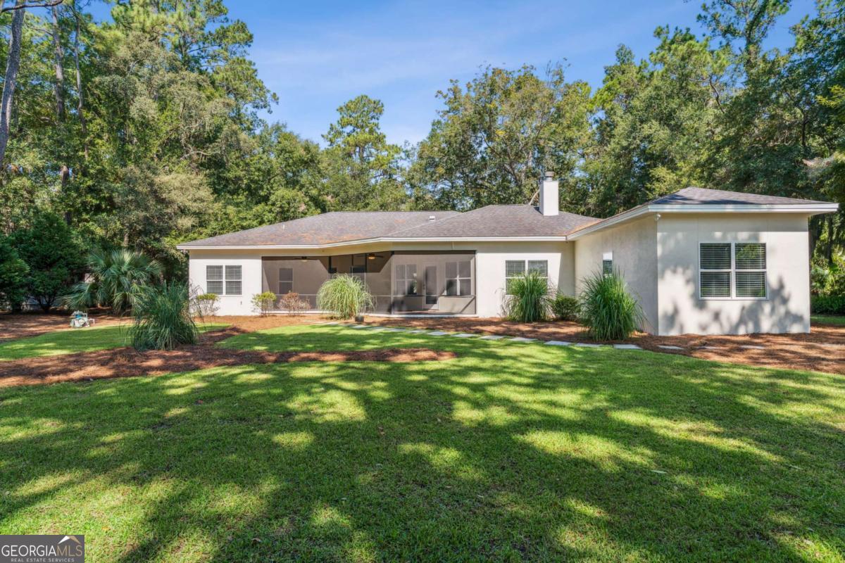 150 Rice Mill St. Simons Island, GA 31522 - Photo 29 of 38 a front view of a house with a garden
