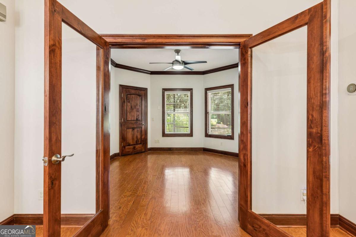 150 Rice Mill St. Simons Island, GA 31522 - Photo 3 of 38 a view of a hallway with wooden floor and a window