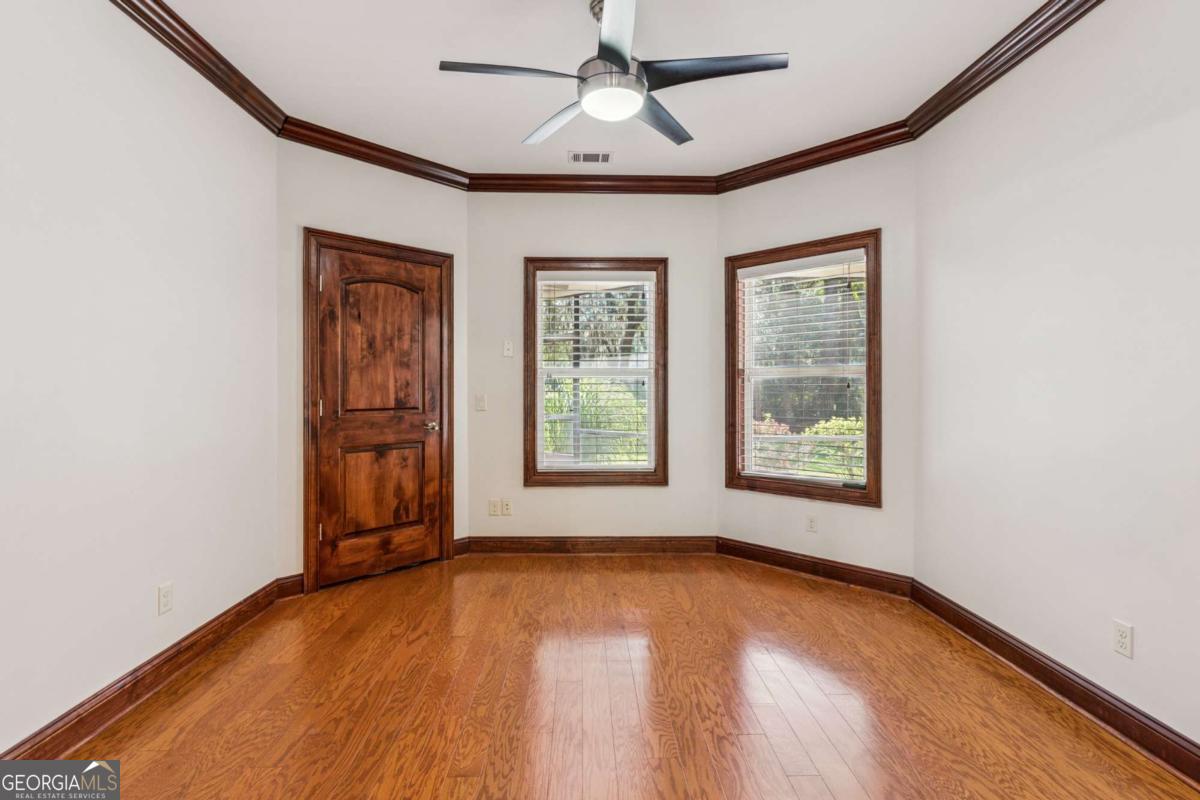 150 Rice Mill St. Simons Island, GA 31522 - Photo 4 of 38 a view of an empty room with a window and wooden floor