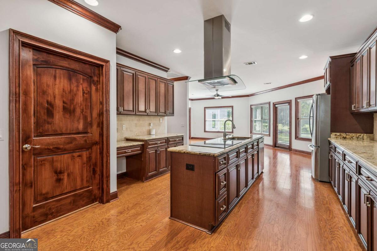 150 Rice Mill St. Simons Island, GA 31522 - Photo 6 of 38 a kitchen with stainless steel appliances granite countertop a stove and a refrigerator