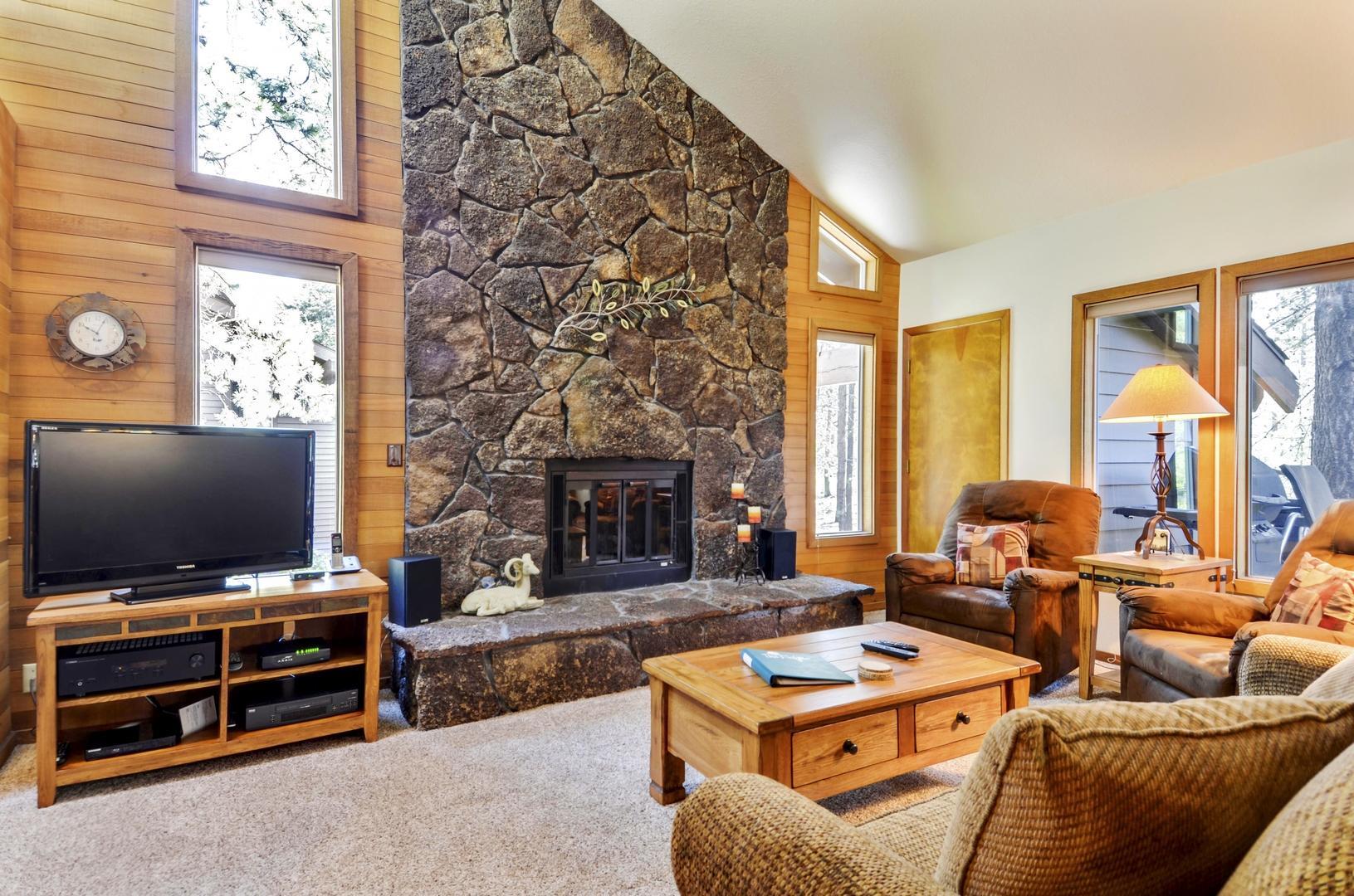 57301 Beaver Ridge Loop, Unit 10 Sunriver, OR 97707 - Photo 6 of 23 a living room with furniture a flat screen tv and a fireplace