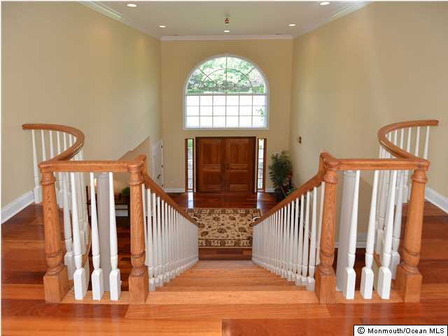 1813 Celeste Drive Wall, NJ 07719 - Photo 16 of 22 a view of a hallway with wooden floor and stairs