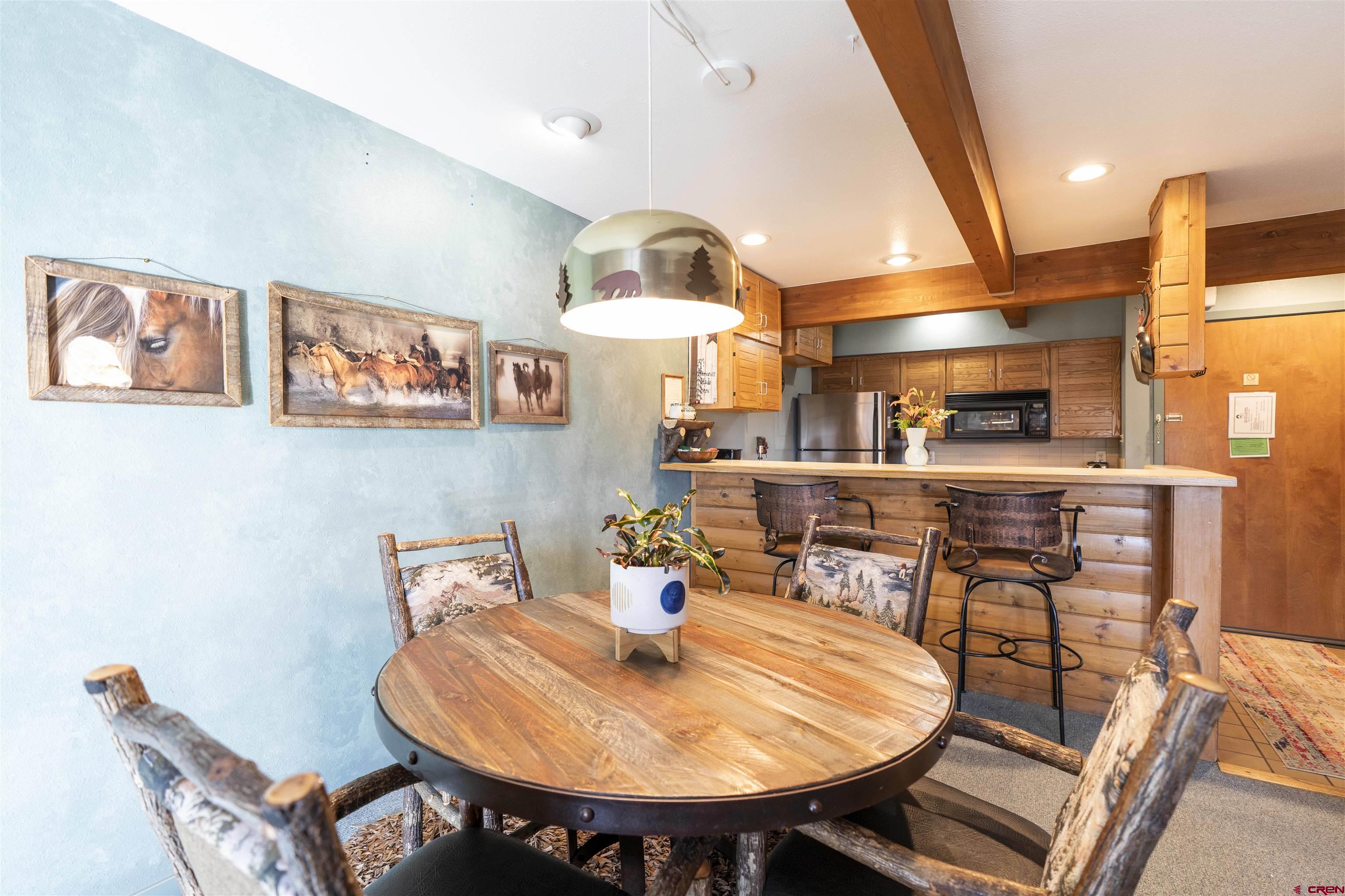 11 Hunter Hill Road, Unit 406 Crested Butte, CO 81225 - Photo 11 of 45 a view of a dining room with furniture and wooden floor