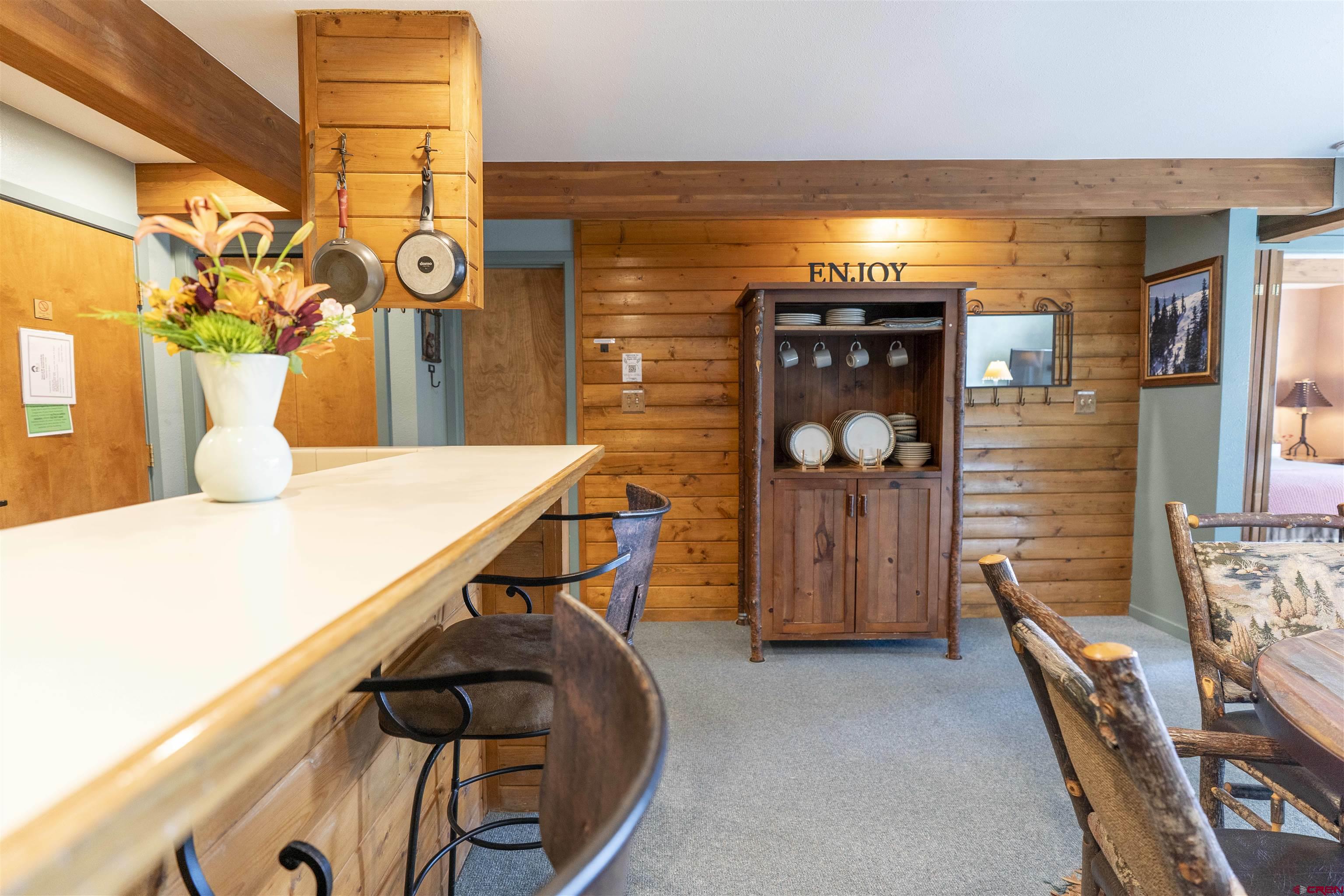 11 Hunter Hill Road, Unit 406 Crested Butte, CO 81225 - Photo 12 of 45 a dining room with furniture and wooden floor