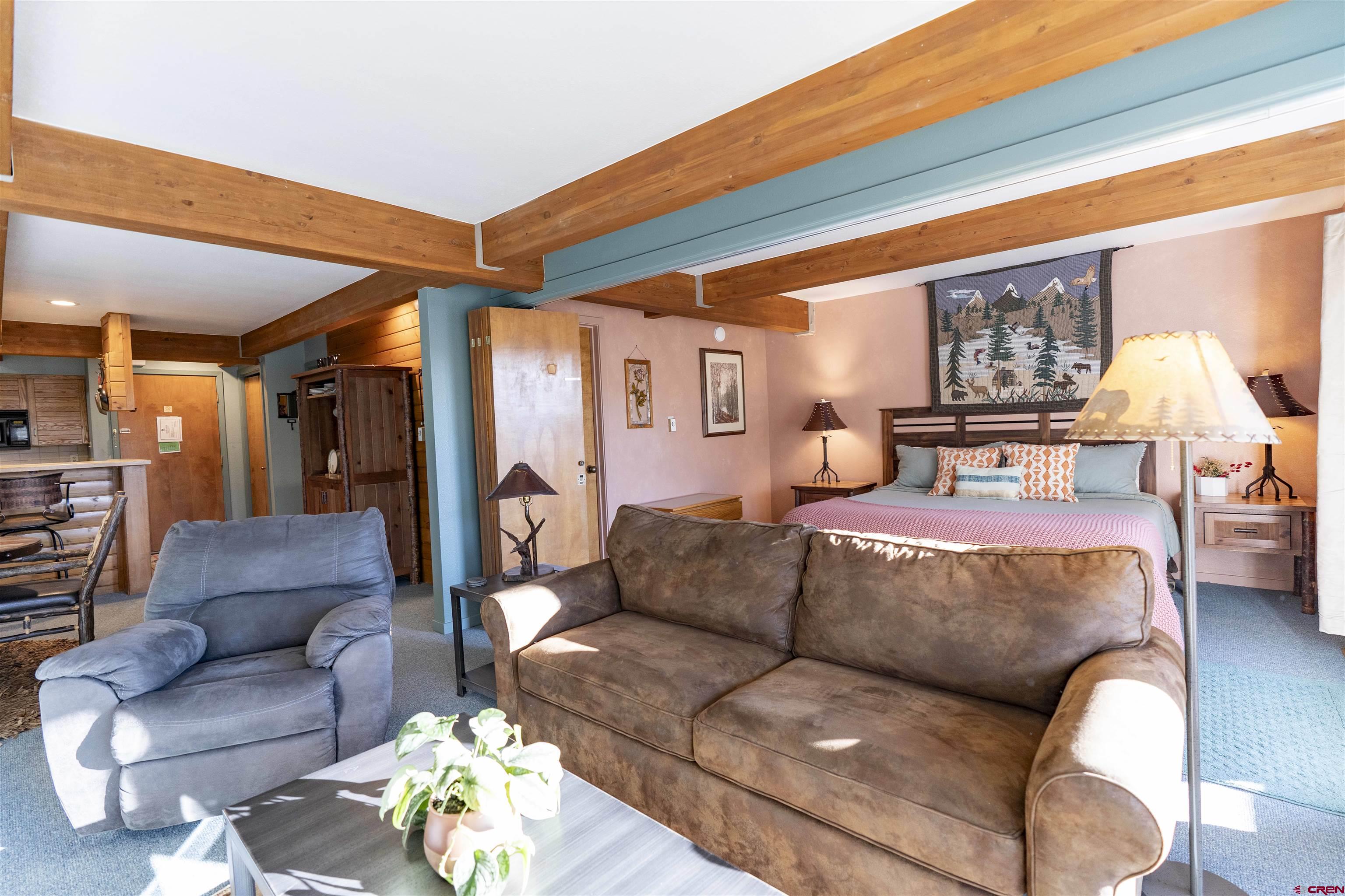 11 Hunter Hill Road, Unit 406 Crested Butte, CO 81225 - Photo 18 of 45 a bedroom with furniture and a couch