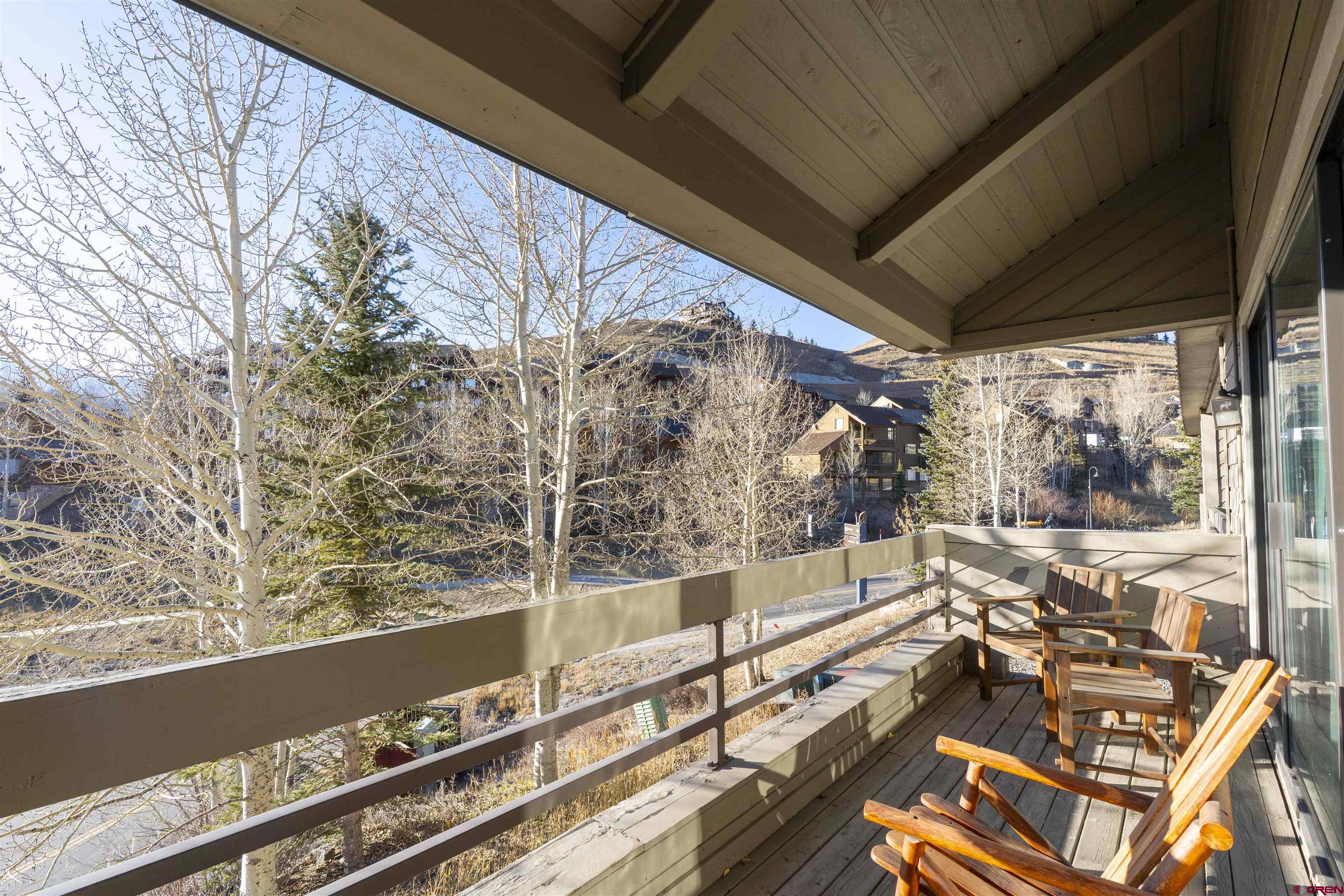 11 Hunter Hill Road, Unit 406 Crested Butte, CO 81225 - Photo 21 of 45 a view of balcony with wooden floor and fence