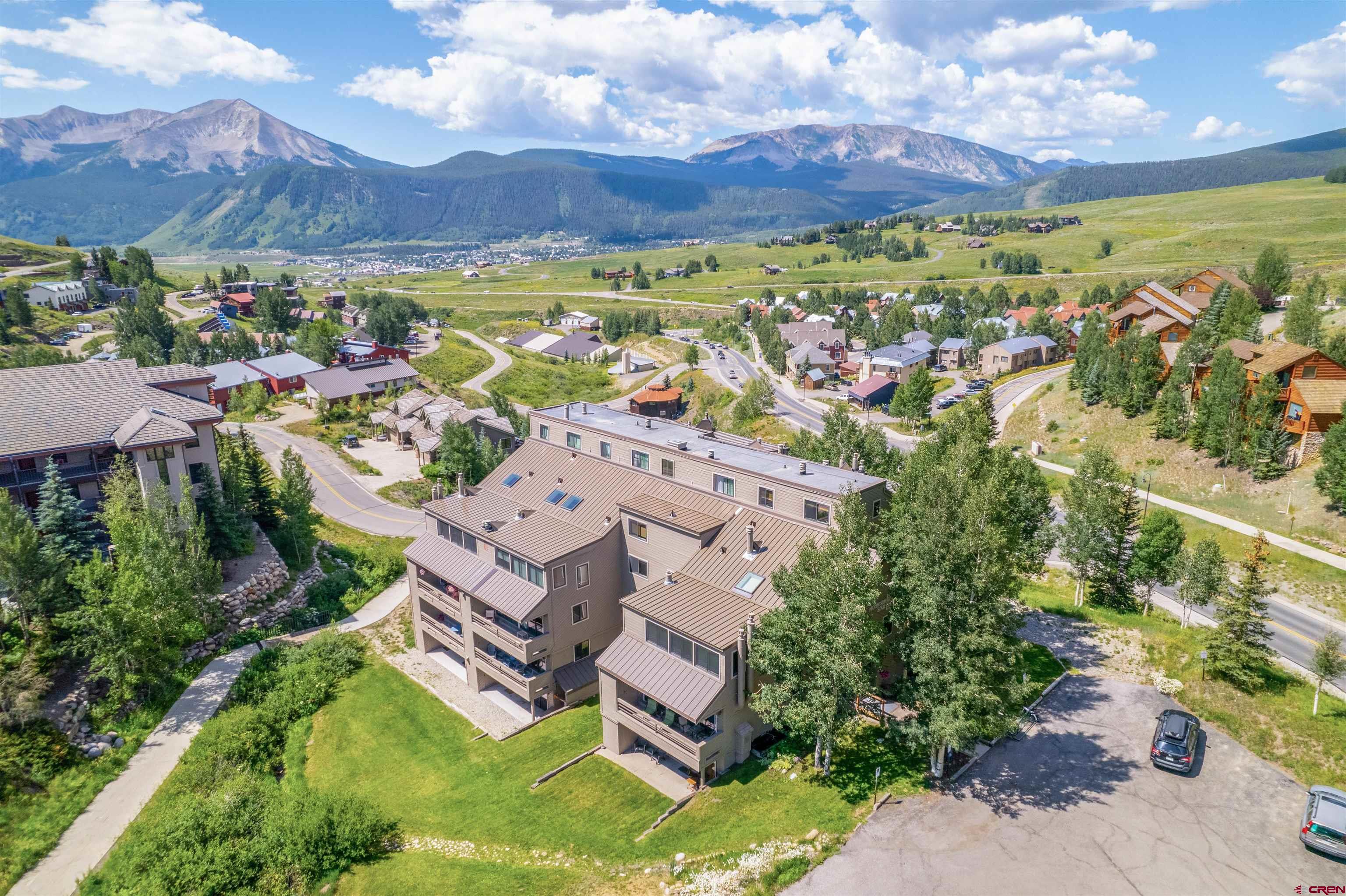 11 Hunter Hill Road, Unit 406 Crested Butte, CO 81225 - Photo 42 of 45 an aerial view of residential houses with outdoor space and ocean view