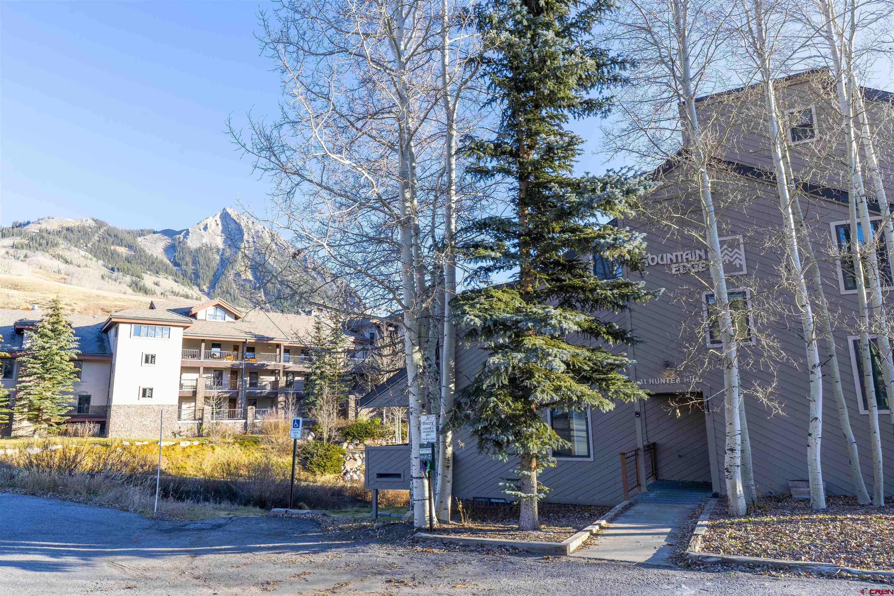 11 Hunter Hill Road, Unit 406 Crested Butte, CO 81225 - Photo 44 of 45 a front view of a building with street view