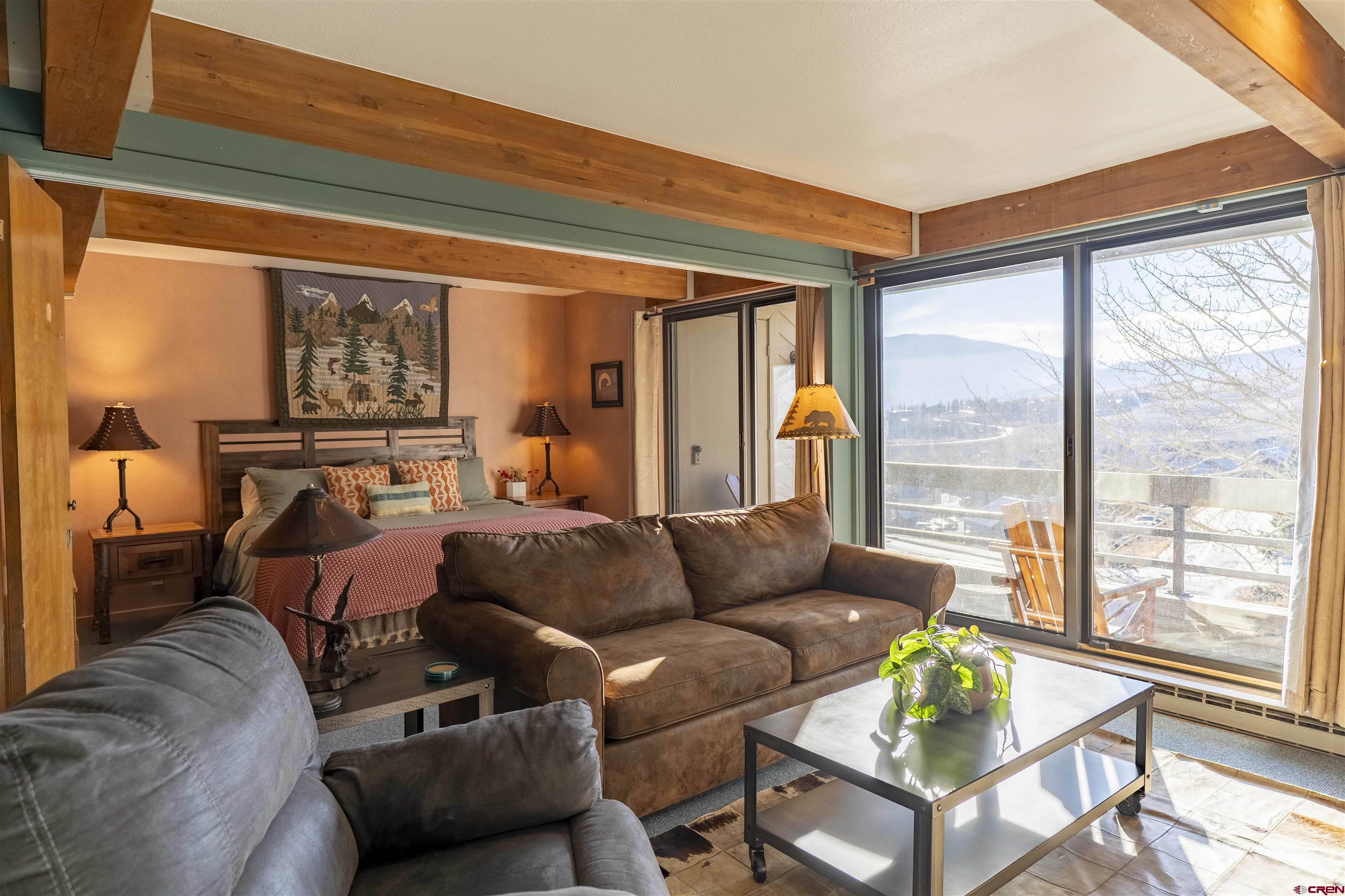 11 Hunter Hill Road, Unit 406 Crested Butte, CO 81225 - Photo 6 of 45 a living room with furniture and a large window