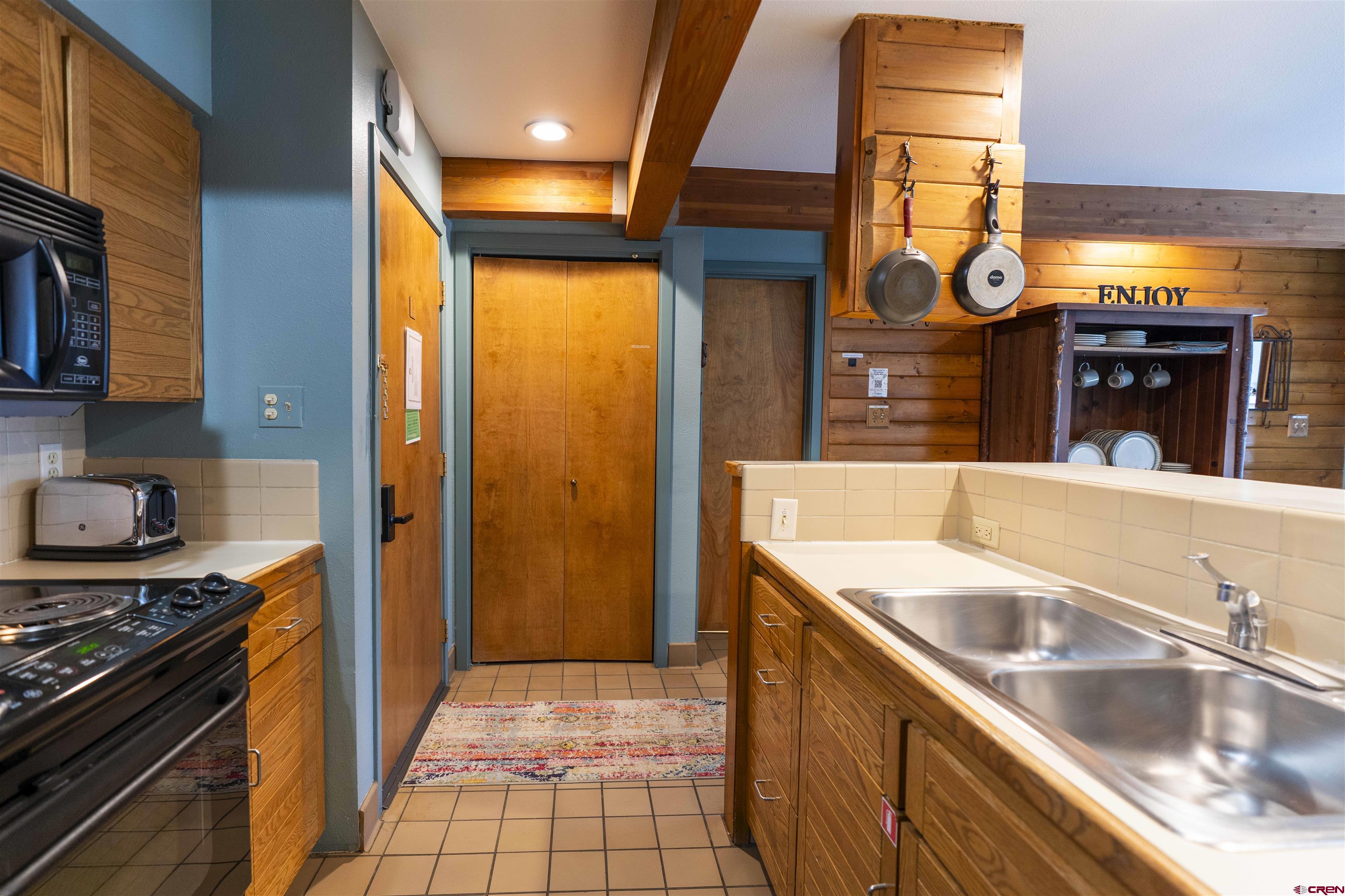 11 Hunter Hill Road, Unit 406 Crested Butte, CO 81225 - Photo 7 of 45 a kitchen with a sink and a stove top oven