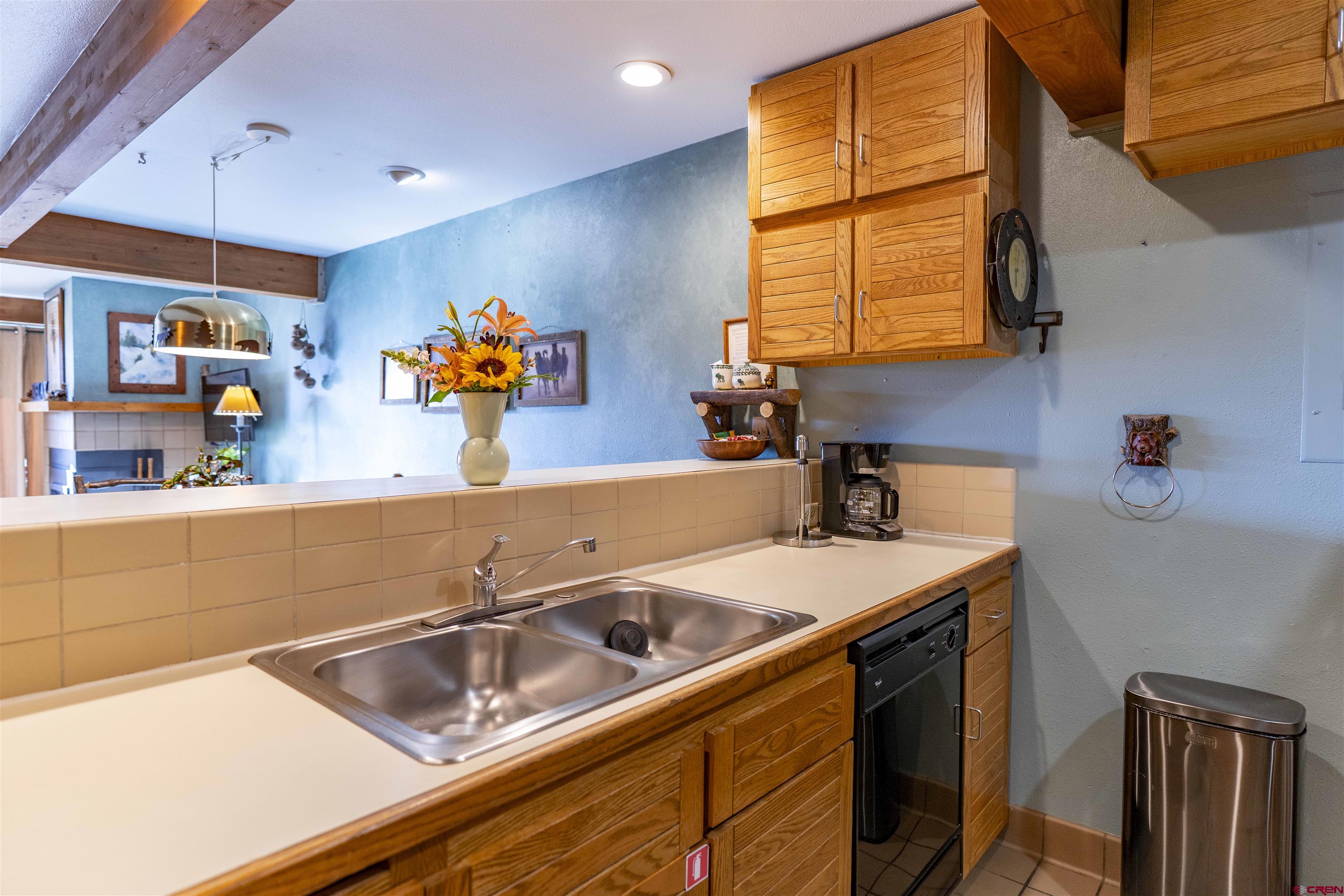 11 Hunter Hill Road, Unit 406 Crested Butte, CO 81225 - Photo 8 of 45 a kitchen with a sink stove and cabinets