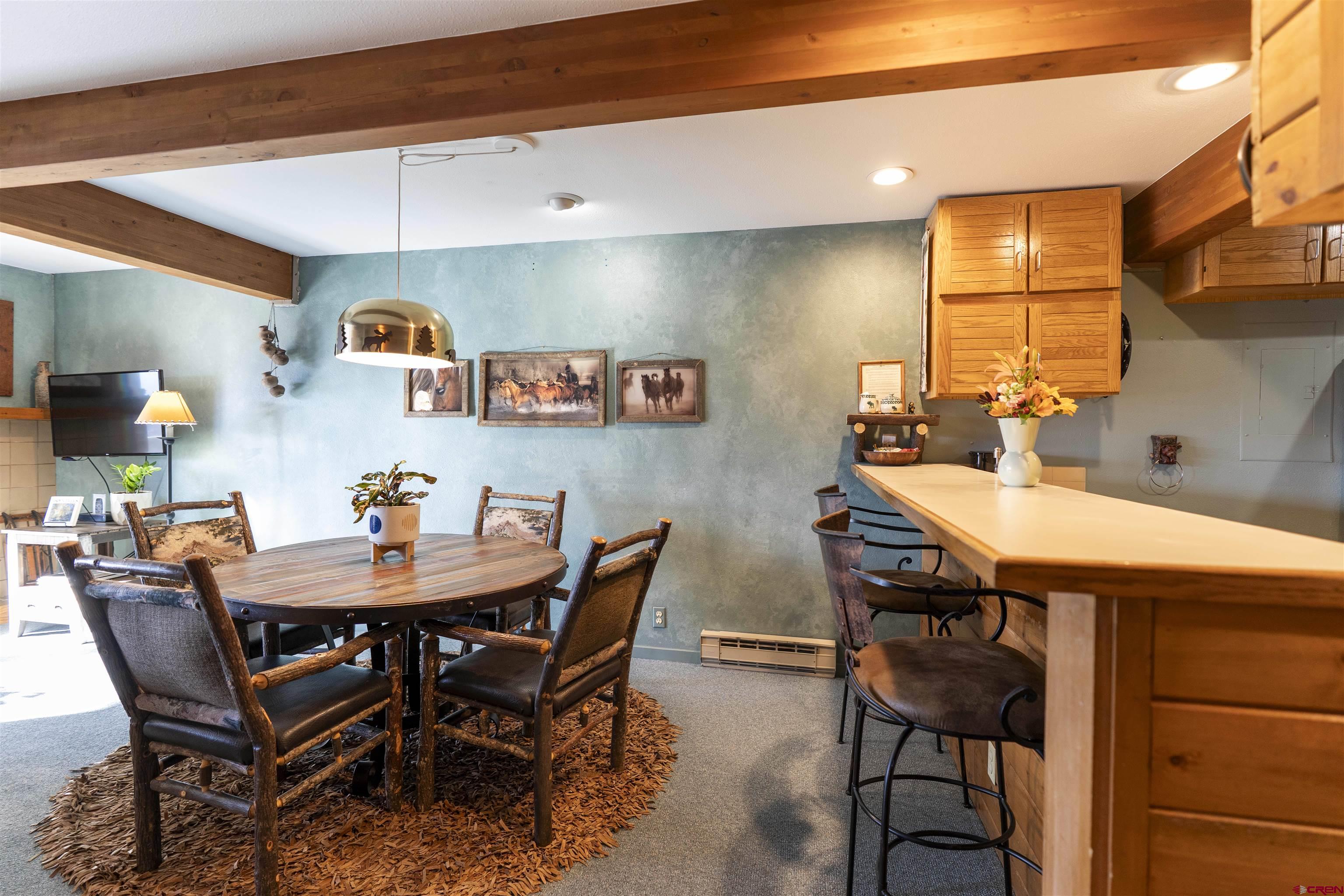 11 Hunter Hill Road, Unit 406 Crested Butte, CO 81225 - Photo 10 of 45 a dining room with a table and chairs