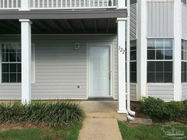 a couple of potted plants in front of door