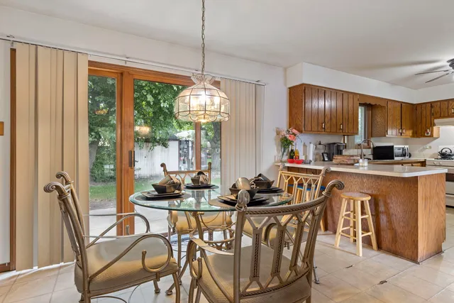a dining room with furniture a chandelier and wooden floor