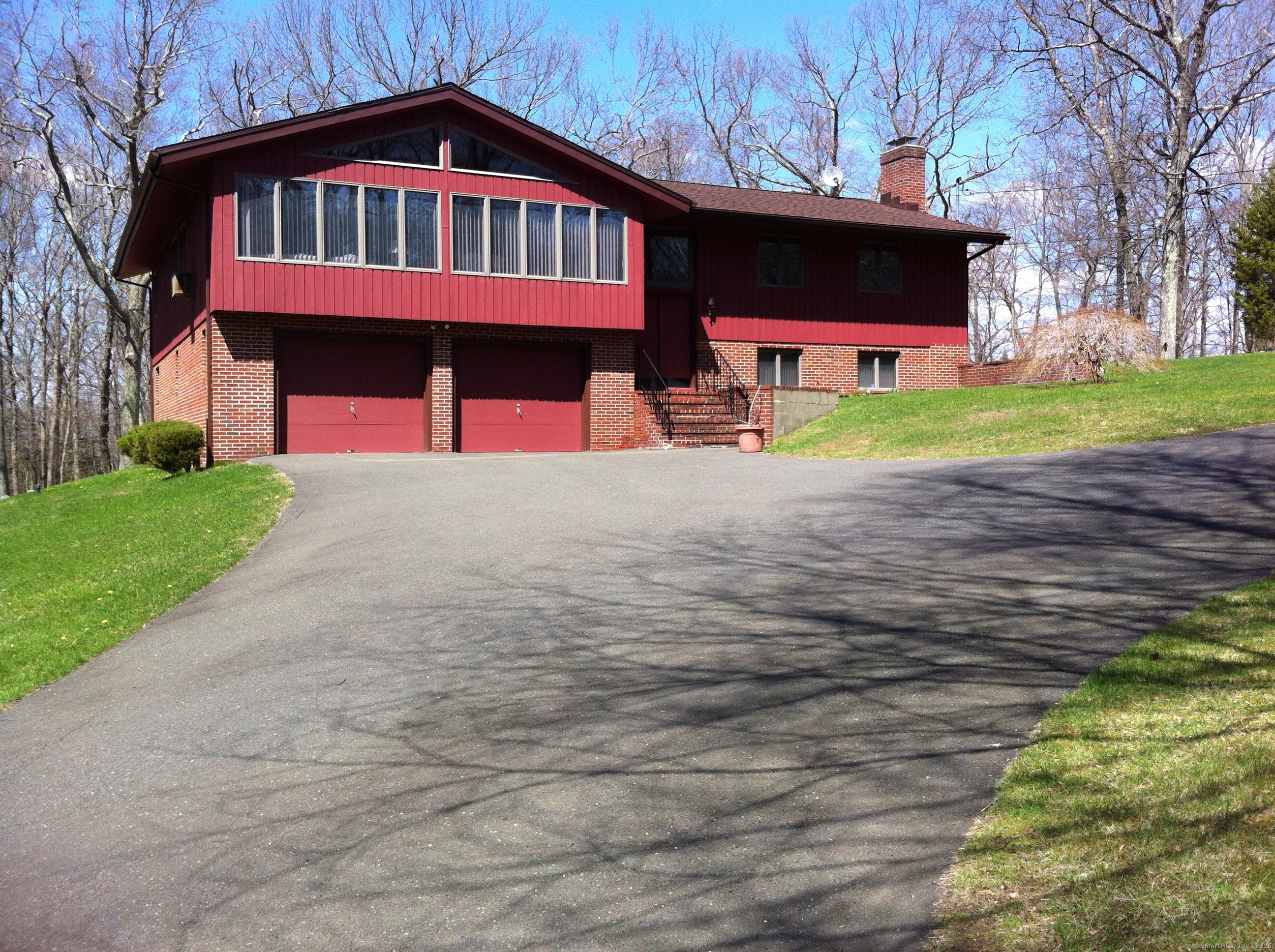30 Bear Hills Road Newtown, CT 06470 - Photo 1 of 1 a front view of a house with a yard and garage
