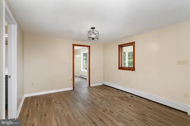 wooden floor in an empty room with a window