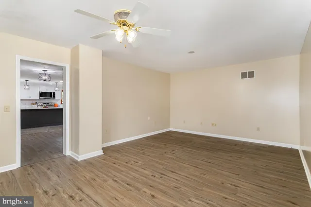 a bathroom with a granite countertop sink mirror vanity and toilet