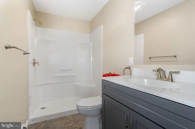 an empty room with a window and a ceiling fan