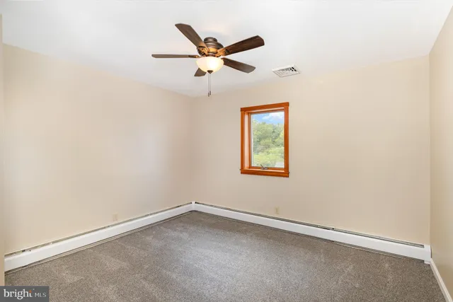 a view of an empty room with wooden walls