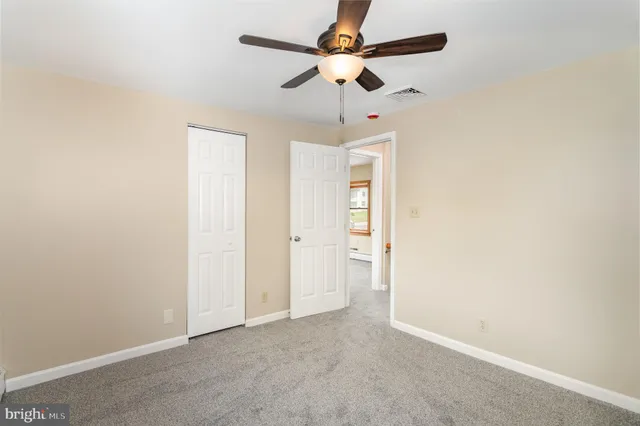 a view of an empty room with wooden fence