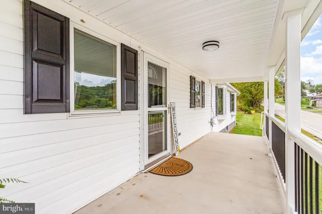 a view of room with stairs and wooden floor