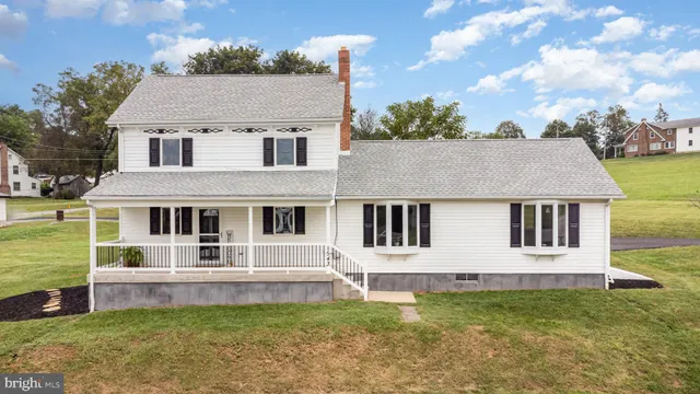 a view of a white house with a yard