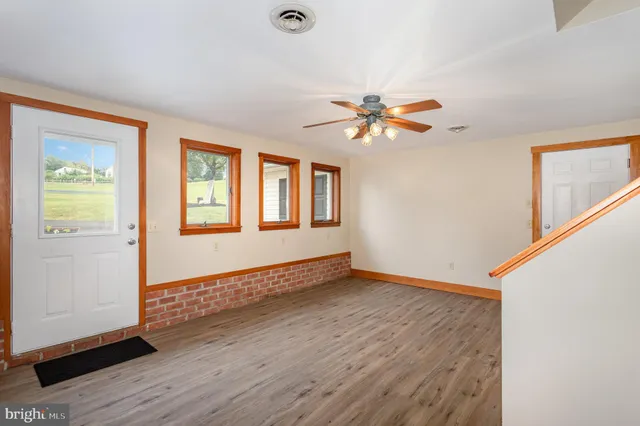 a large kitchen with sink a refrigerator and windows