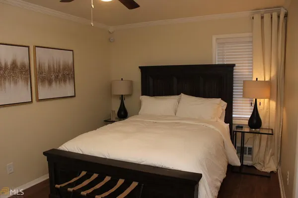 a bed sitting in a bedroom next to a window