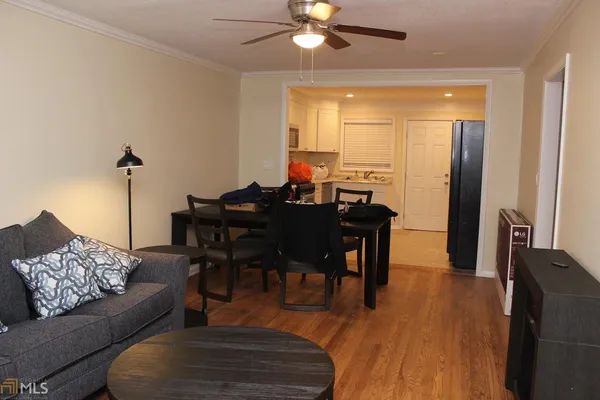 a living room with furniture and wooden floor