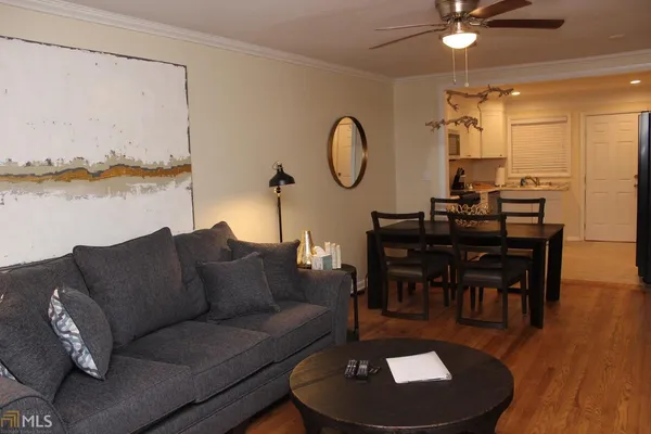 a living room with furniture a rug and a chandelier