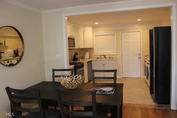 a view of a dining room with furniture and a potted plant