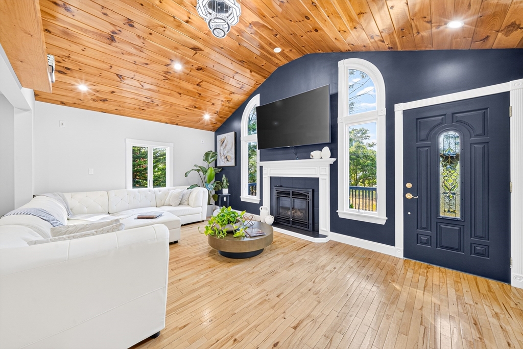 24 Miller Road Wilmington, MA 01887 - Photo 6 of 40 a living room with furniture fireplace and flat screen tv