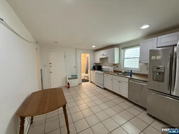 a large kitchen with cabinets and stainless steel appliances
