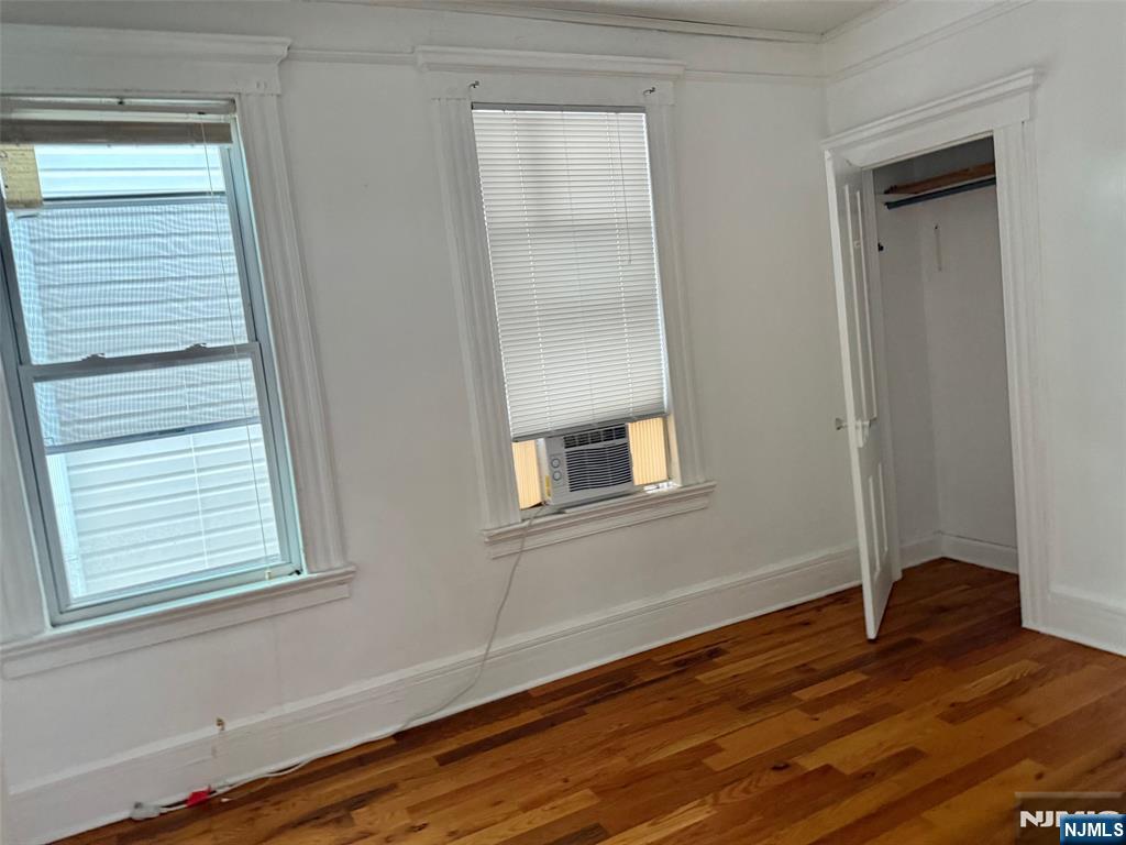 44 Washington Street, Unit 2F Harrison, NJ 07029 - Photo 4 of 9 a view of an empty room with wooden floor and a window