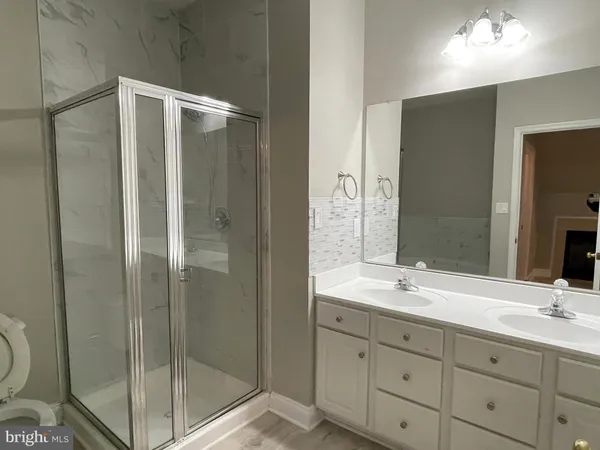 a white bath tub sitting next to a white toilet