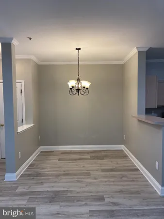 a view of wooden floor chandelier and window in a room