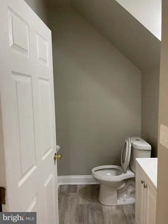 a white toilet sitting next to a white cabinet
