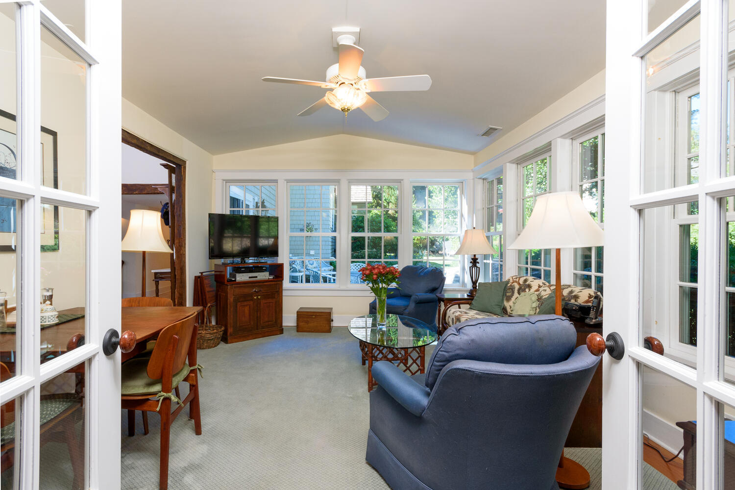 327 Hollow Tree Ridge Road Darien, CT 06820 - Photo 11 of 37 a living room with furniture a chandelier and a flat screen tv