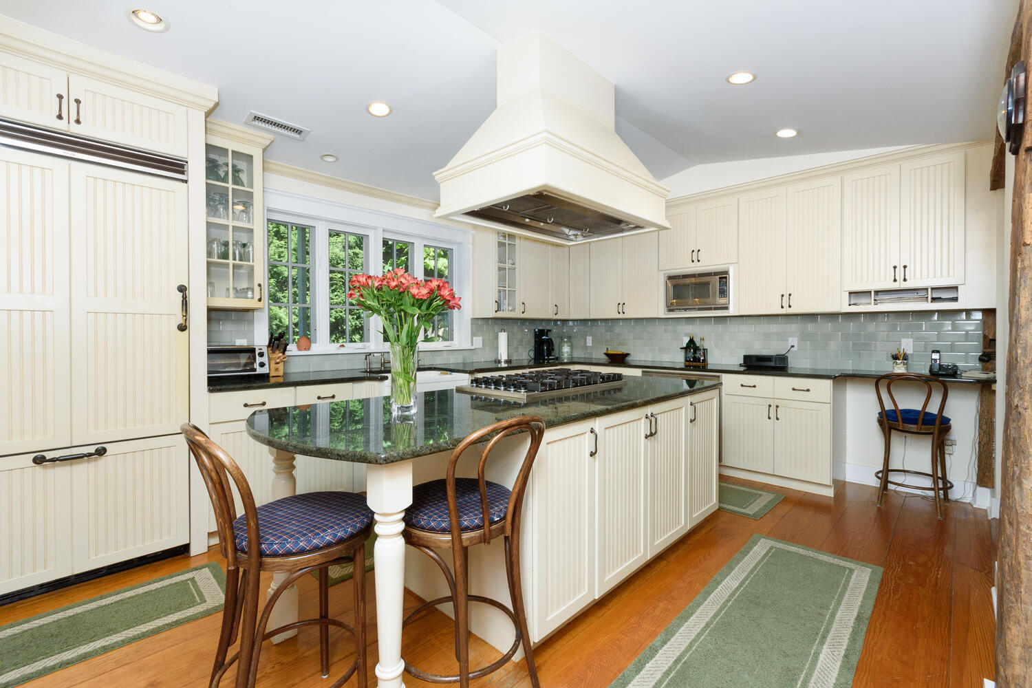 327 Hollow Tree Ridge Road Darien, CT 06820 - Photo 13 of 37 a kitchen with stainless steel appliances granite countertop table chairs sink and cabinets