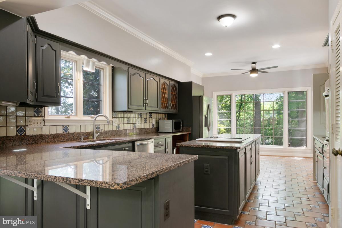 613 Rivercrest Drive McLean, VA 22101 - Photo 14 of 40 a kitchen with granite countertop sink stove and cabinets