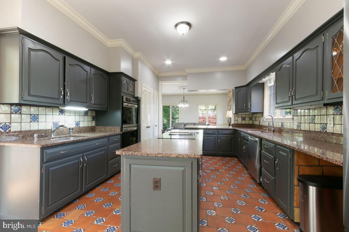 613 Rivercrest Drive McLean, VA 22101 - Photo 15 of 40 a kitchen with kitchen island granite countertop a sink counter top space appliances and cabinets