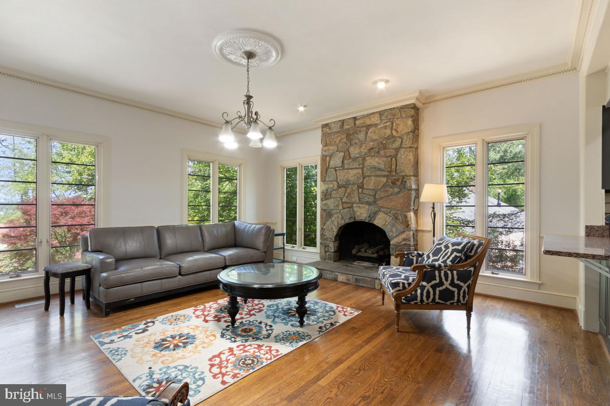 613 Rivercrest Drive McLean, VA 22101 - Photo 18 of 40 a living room with furniture a fireplace and a chandelier