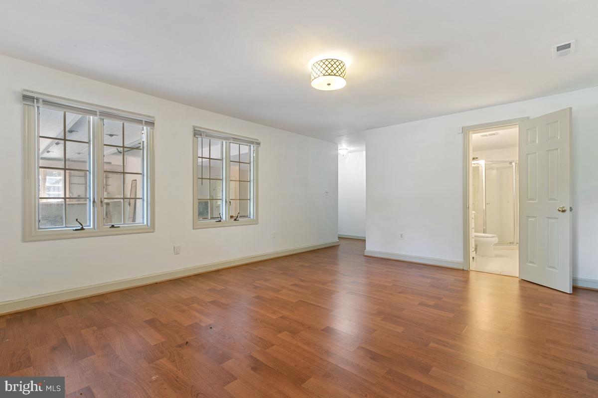 613 Rivercrest Drive McLean, VA 22101 - Photo 40 of 40 an empty room with wooden floor and windows