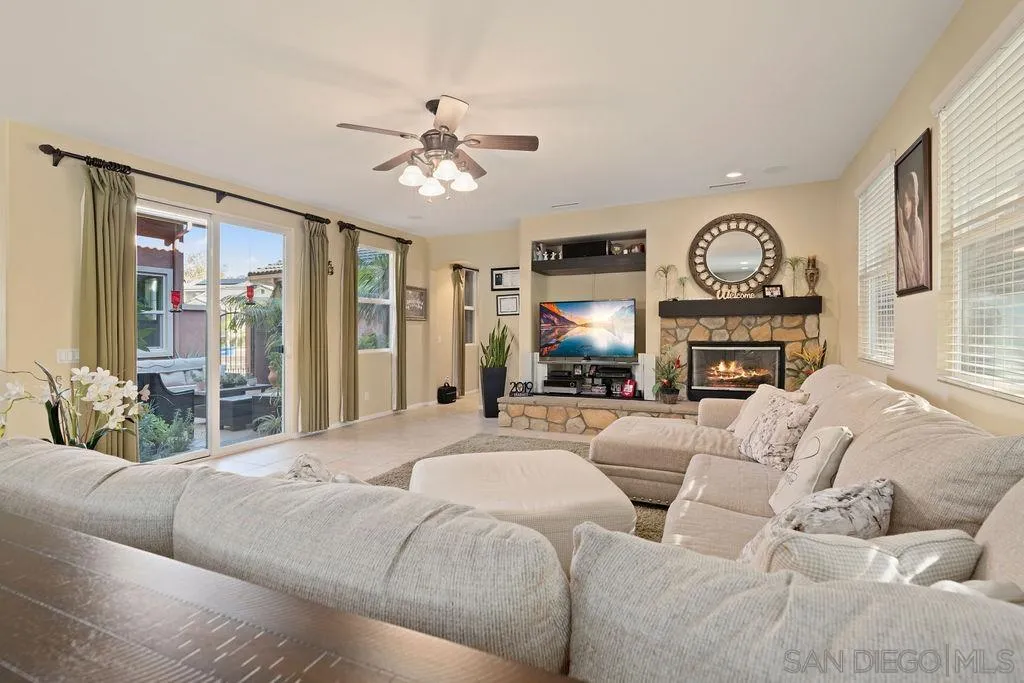 197 Double Eagle Glen Escondido, CA 92026 - Photo 15 of 70 a living room with furniture a fireplace and a flat screen tv