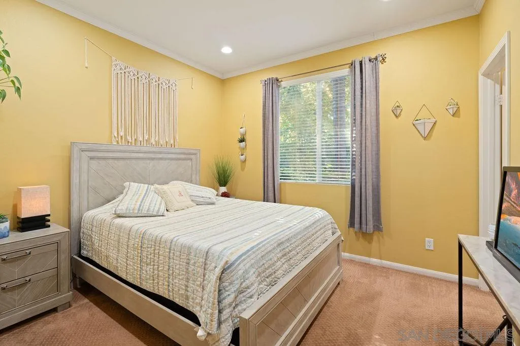 197 Double Eagle Glen Escondido, CA 92026 - Photo 17 of 70 a bedroom with a bed and a window