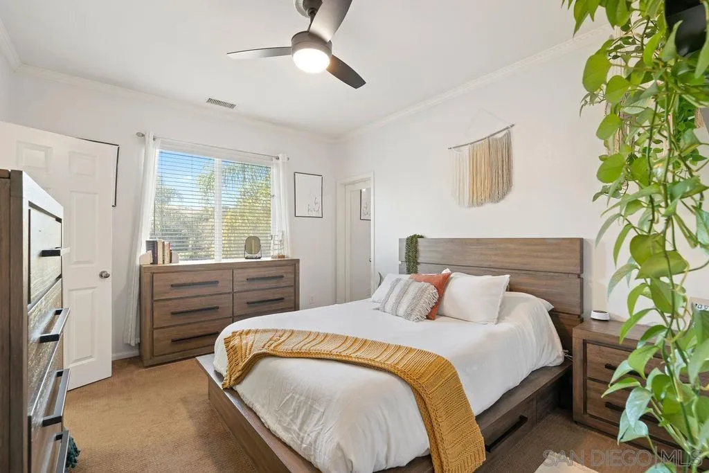 197 Double Eagle Glen Escondido, CA 92026 - Photo 31 of 70 a bedroom with a bed and a potted plant