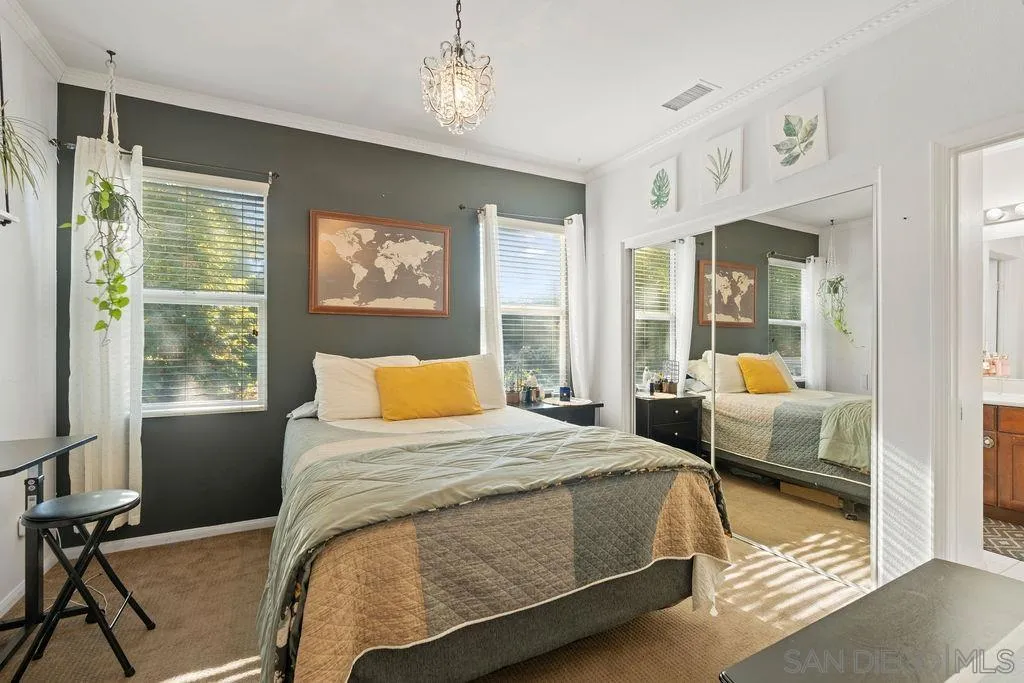 197 Double Eagle Glen Escondido, CA 92026 - Photo 32 of 70 a bedroom with a large bed and a chandelier